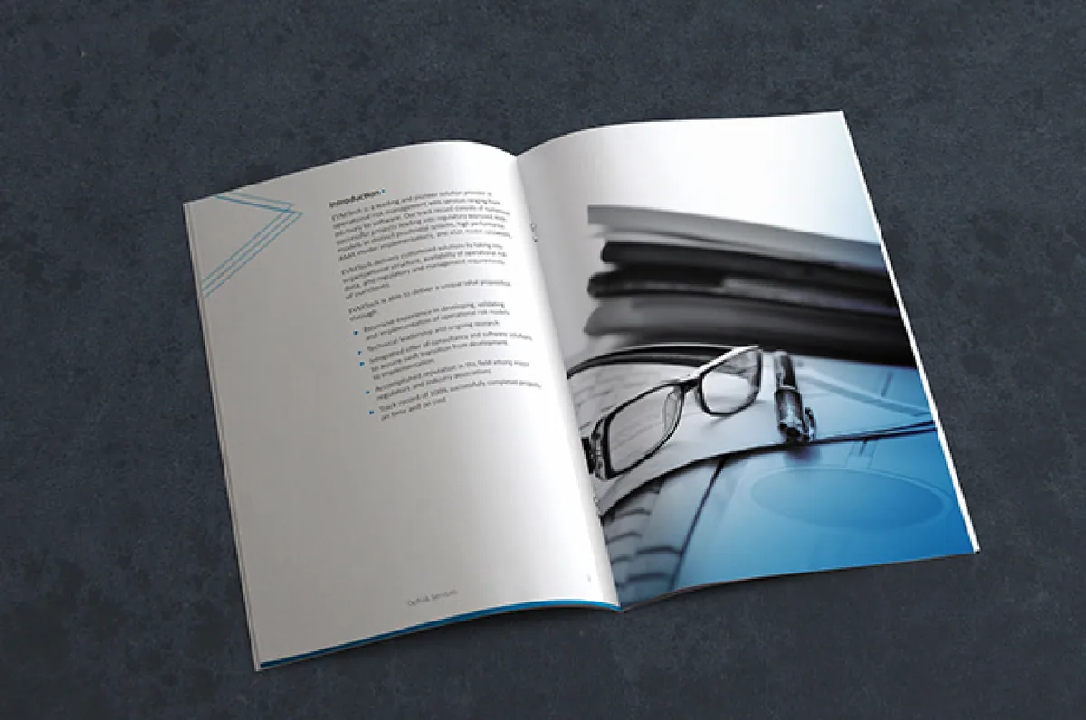 An open printed booklet on a dark surface
